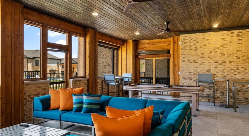 a patio with a pool table and couch